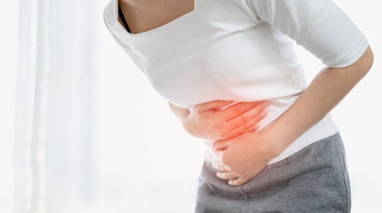 Young woman put her hand on her stomach because she had a very bad stomachache. menstrual pain, gastritis or diarrhea concept