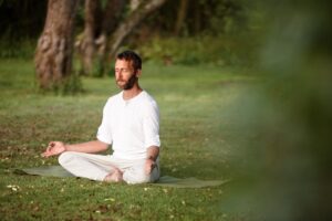Yoga, health and meditation with man in nature for lotus pose, peace and exercise balance.